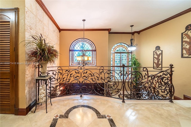 hall featuring ornamental molding and an inviting chandelier