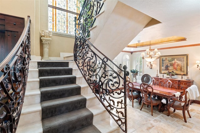 stairs featuring a notable chandelier