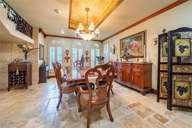 dining room with crown molding and a notable chandelier