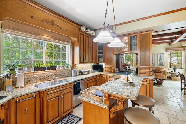 kitchen featuring a breakfast bar, dishwasher, a wealth of natural light, and a kitchen island