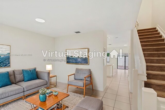 kitchen with sink, light tile patterned floors, appliances with stainless steel finishes, white cabinets, and kitchen peninsula