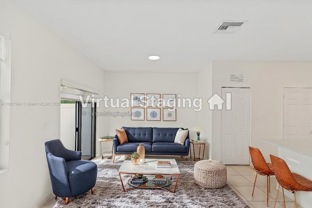 living room featuring visible vents and light tile patterned floors