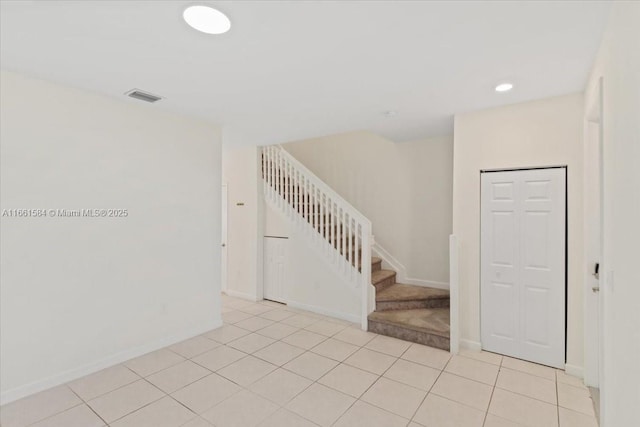 stairs with tile patterned floors