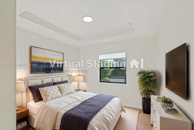 carpeted bedroom featuring a tray ceiling