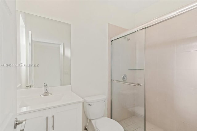 bathroom featuring a shower with door, vanity, and toilet