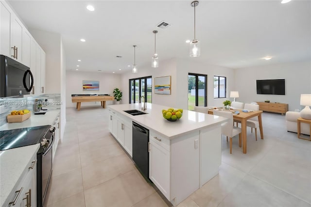 kitchen featuring a center island with sink, sink, white cabinetry, and black appliances