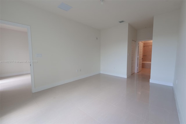 unfurnished room featuring light tile patterned floors