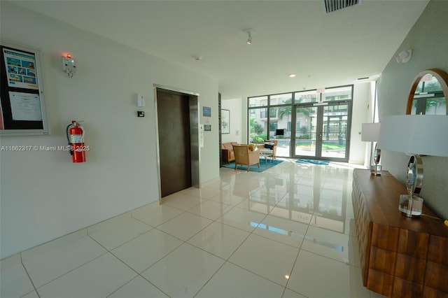 interior space featuring light tile patterned floors, floor to ceiling windows, french doors, and elevator