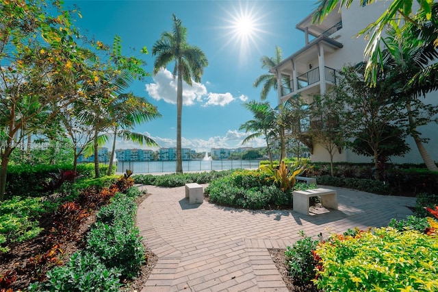 view of property's community featuring a water view and a patio area