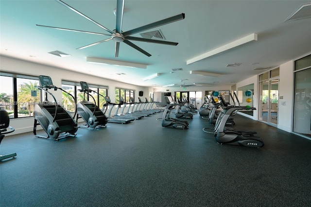 gym with a healthy amount of sunlight, ceiling fan, and french doors