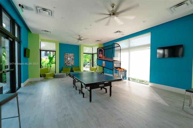 rec room with ceiling fan and light hardwood / wood-style floors