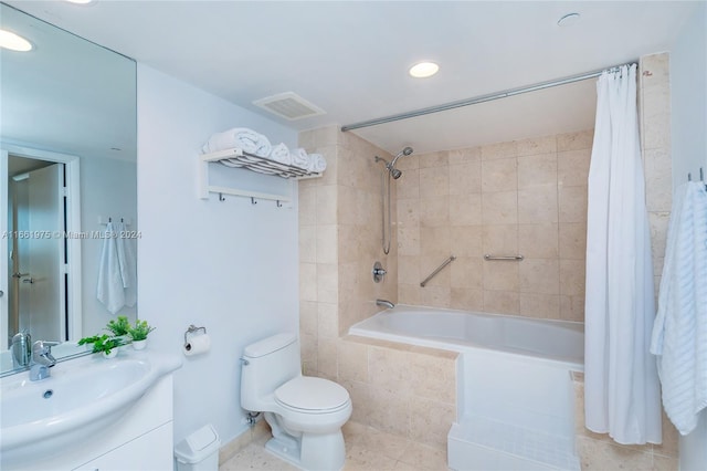 full bathroom featuring shower / bath combination with curtain, vanity, tile patterned flooring, and toilet