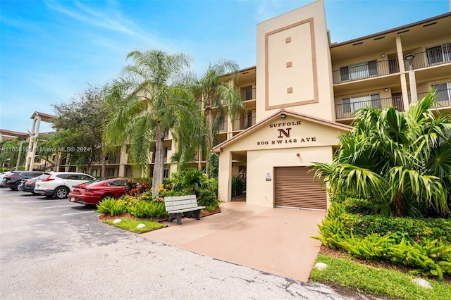 view of front of house featuring a balcony and a garage