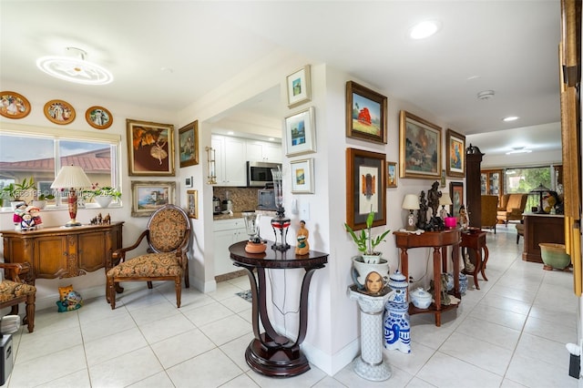 corridor featuring light tile patterned floors and a wealth of natural light