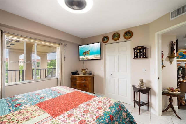 bedroom featuring a closet and light tile patterned floors