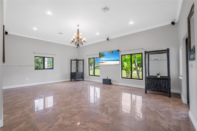 unfurnished living room featuring crown molding, plenty of natural light, and an inviting chandelier