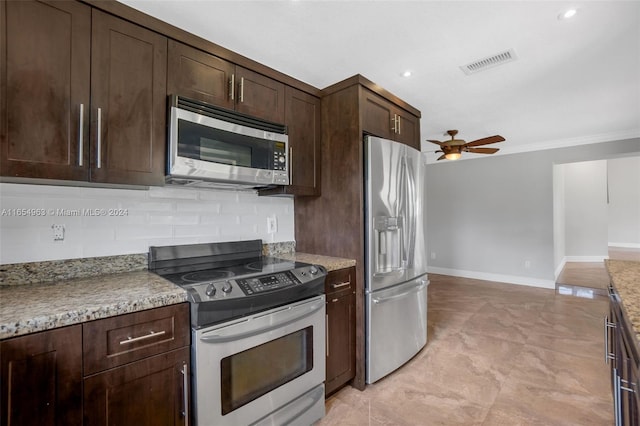 kitchen featuring appliances with stainless steel finishes, tasteful backsplash, ornamental molding, dark brown cabinetry, and ceiling fan