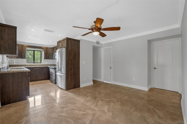 kitchen featuring appliances with stainless steel finishes, ornamental molding, a sink, dark brown cabinetry, and baseboards