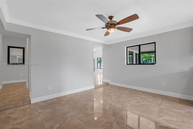 spare room with ceiling fan and ornamental molding