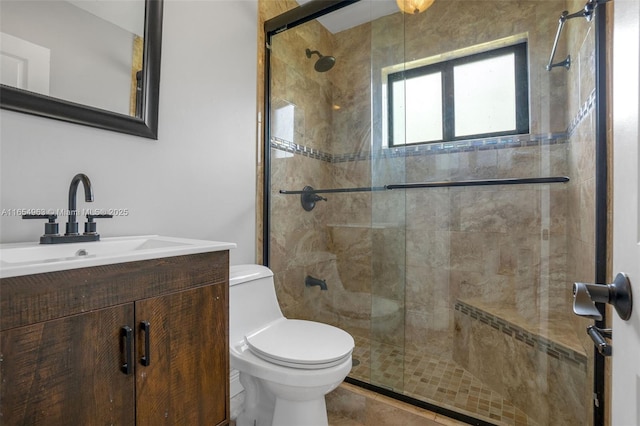 full bathroom featuring a shower stall, toilet, and vanity