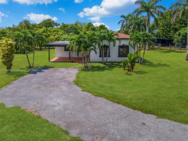 exterior space with a front lawn and a carport