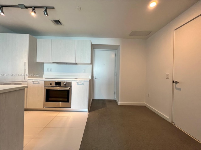 kitchen featuring light tile patterned floors, black stovetop, and stainless steel oven