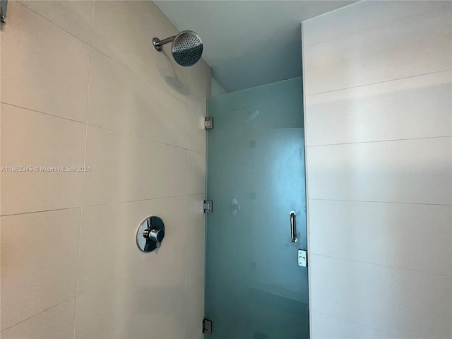 bathroom with a shower with shower door