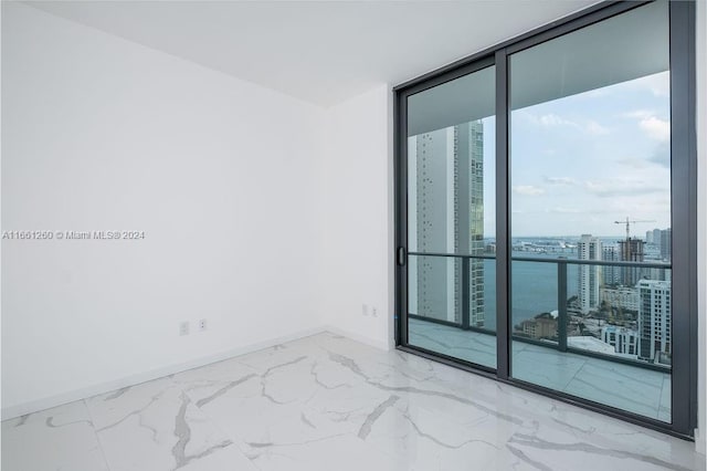 unfurnished room featuring floor to ceiling windows