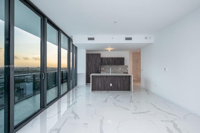 interior space featuring floor to ceiling windows and sink