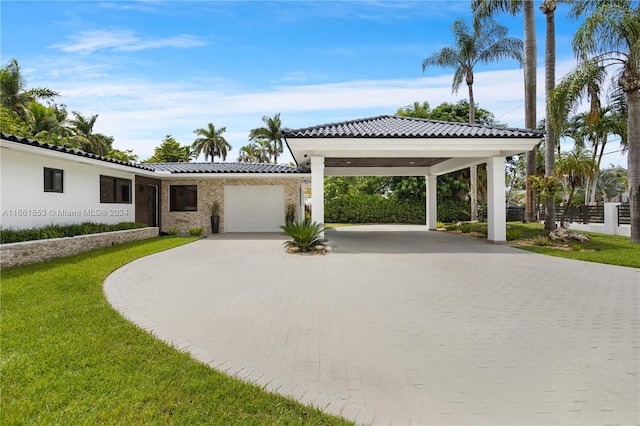 view of front of property with a garage, a front lawn, and a carport