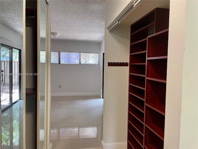 spacious closet featuring light tile patterned floors