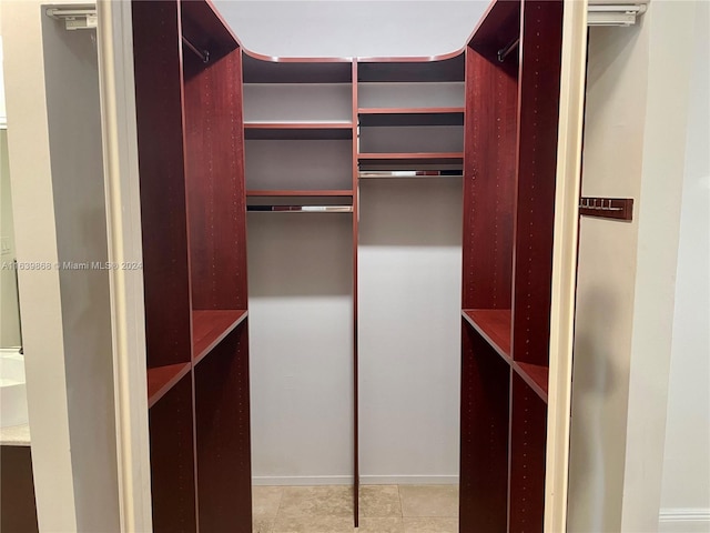 spacious closet featuring light tile patterned floors