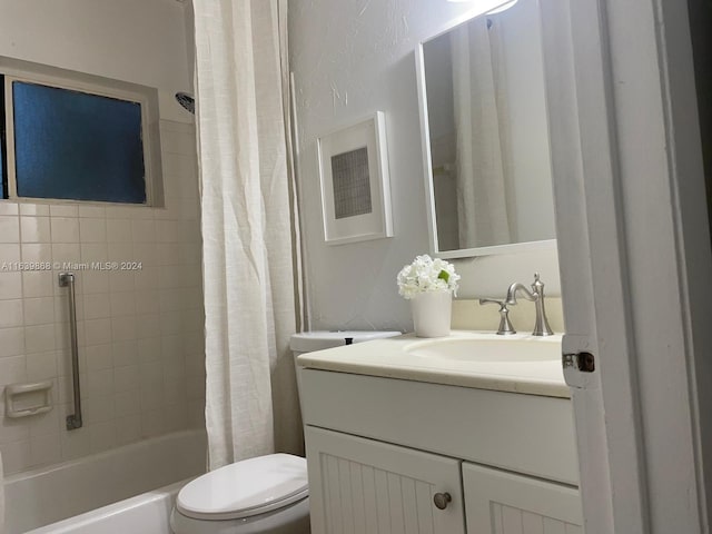 full bathroom featuring shower / bath combination with curtain, vanity, and toilet