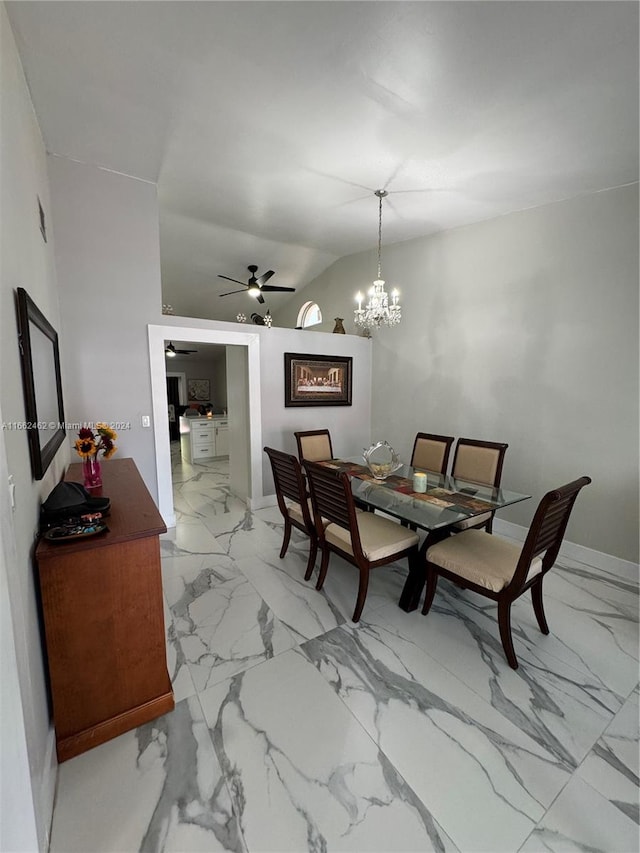 dining space featuring ceiling fan with notable chandelier and vaulted ceiling