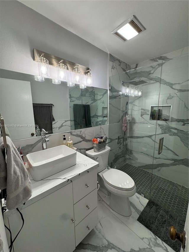 bathroom featuring vanity, toilet, and a shower with door