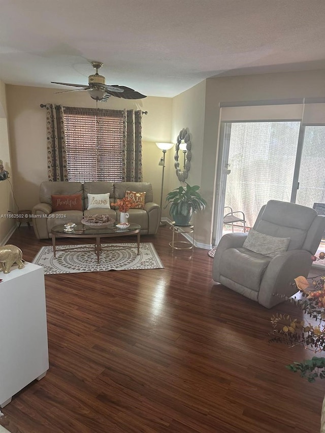 living room with ceiling fan and dark hardwood / wood-style flooring