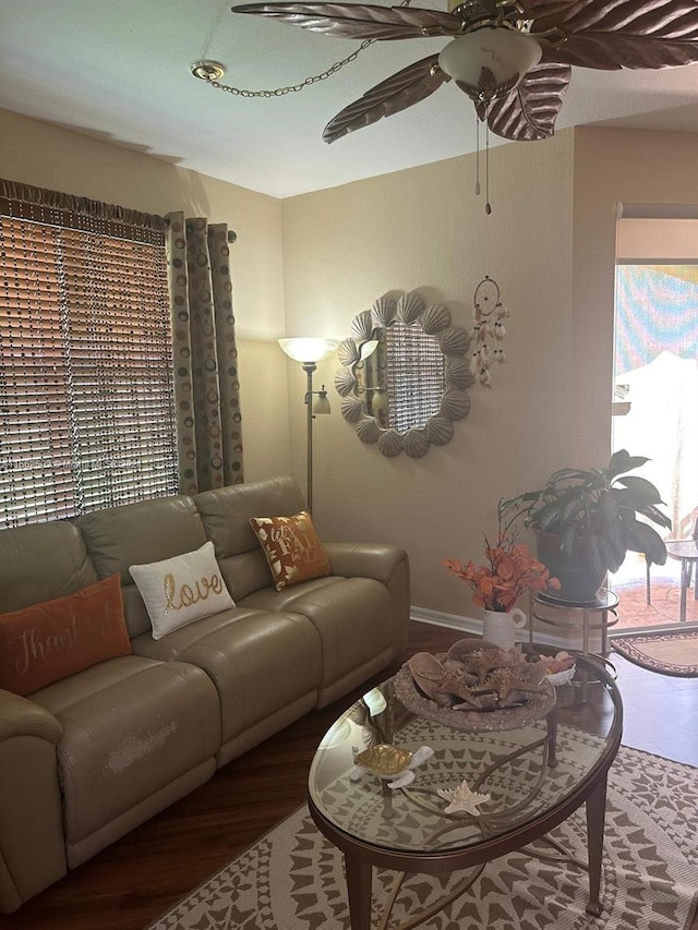 living room featuring wood-type flooring and ceiling fan