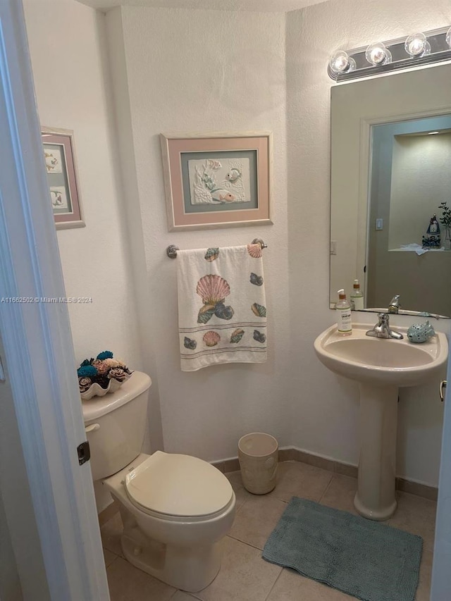 bathroom featuring tile patterned flooring and toilet