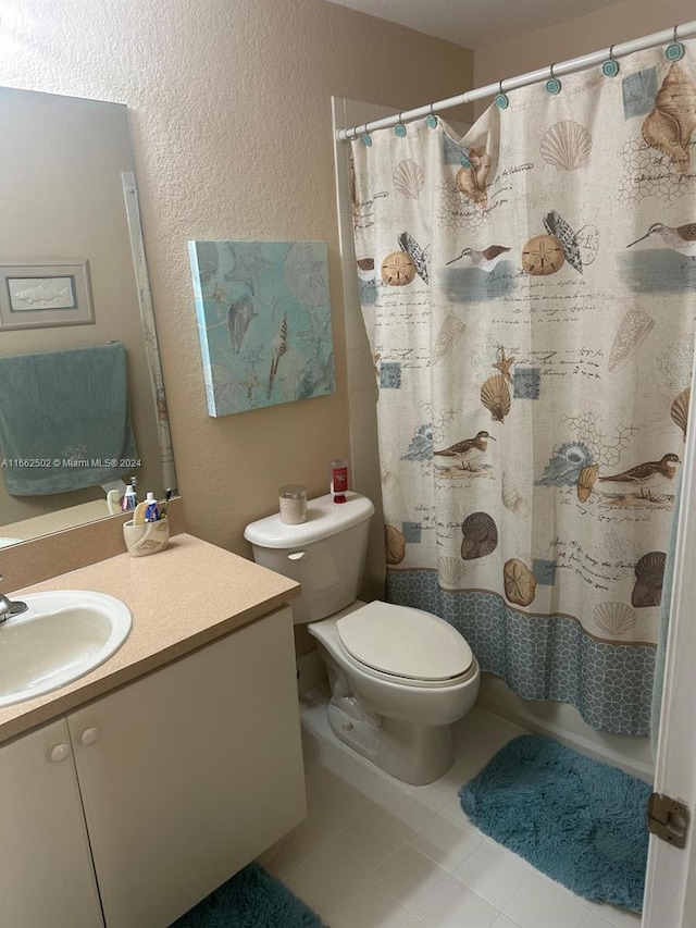 bathroom featuring tile patterned floors, vanity, and toilet