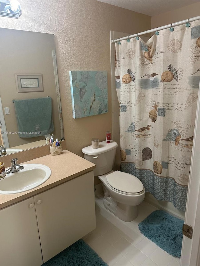 bathroom featuring vanity, toilet, and tile patterned floors