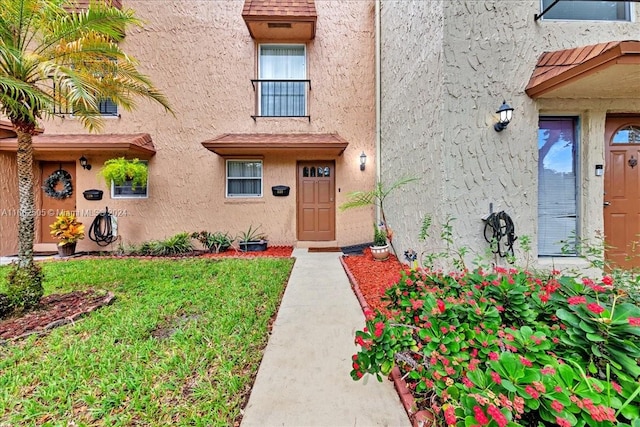 entrance to property with a yard