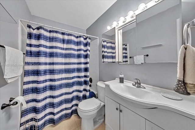 bathroom featuring walk in shower, vanity, toilet, and tile patterned flooring