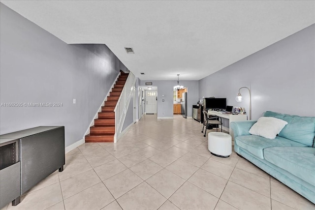 living room with a chandelier and light tile patterned floors