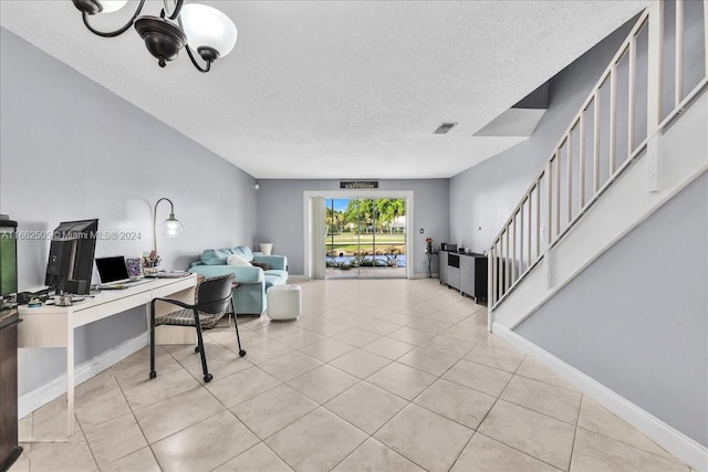 living room with built in desk, a textured ceiling, and light tile patterned floors