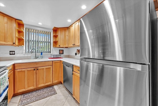 kitchen featuring light tile patterned floors, stainless steel appliances, and sink