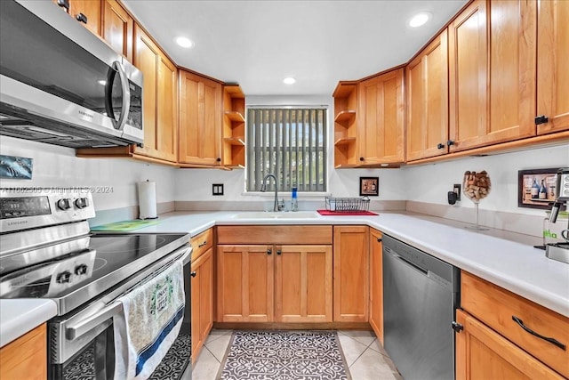 kitchen with light tile patterned flooring, stainless steel appliances, and sink