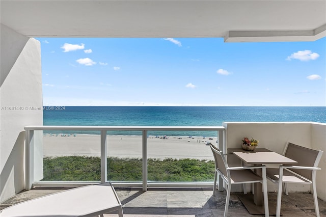 balcony with a water view and a beach view