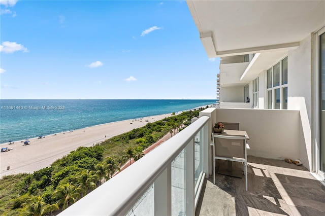 balcony with a beach view and a water view