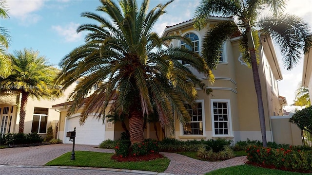 mediterranean / spanish-style home with a garage