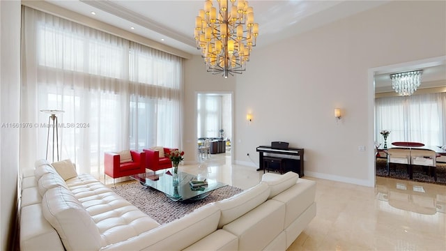 living room with an inviting chandelier and a towering ceiling